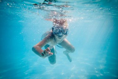 Boy swimming under water clipart