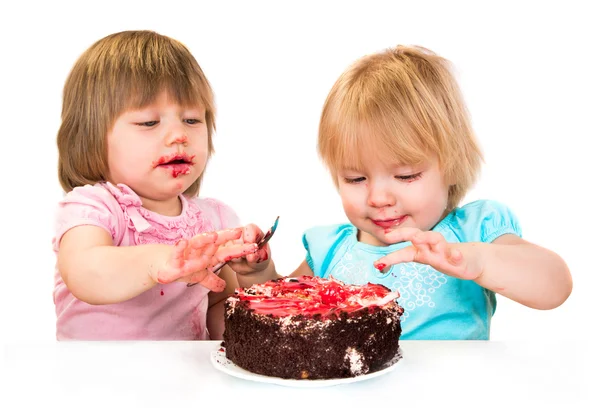 Two little baby girl eating cake — Stock Photo, Image