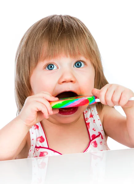 Bebé comiendo una piruleta pegajosa Fotos De Stock Sin Royalties Gratis