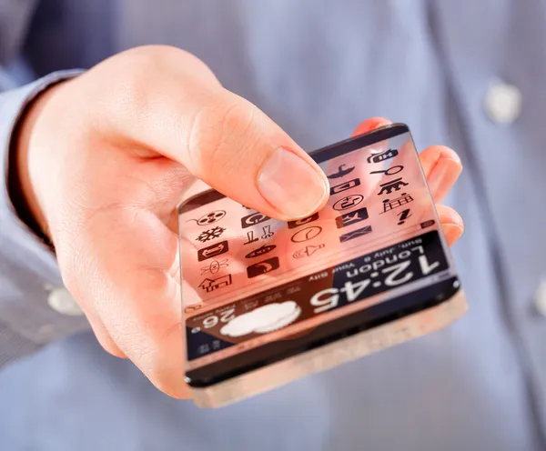 Smartphone med transparent skärm i mänskliga händer. — Stockfoto