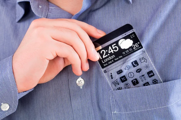 Smartphone con una pantalla transparente en un bolsillo de camisa . —  Fotos de Stock