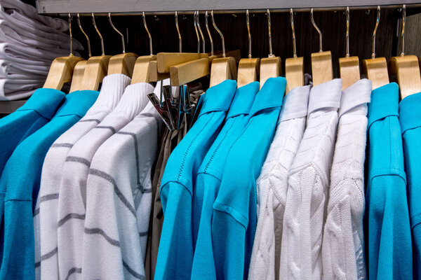 Clothing on hangers in shop