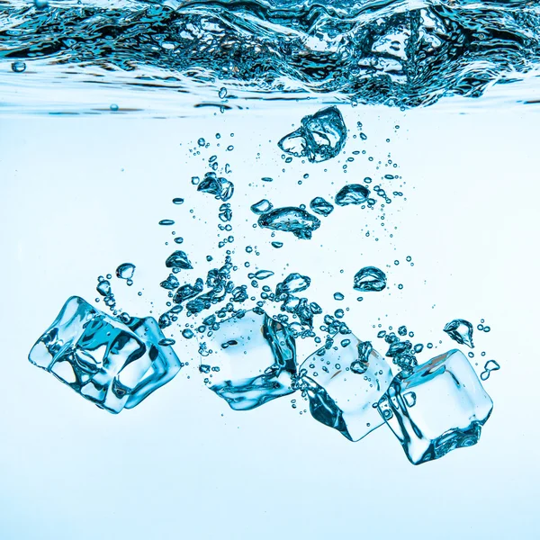 Ice cubes falling under water — Stock Photo, Image
