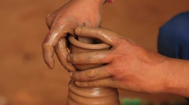 Potter iş yerinde seramik yemekler yapıyor. Hindistan, Rajasthan.