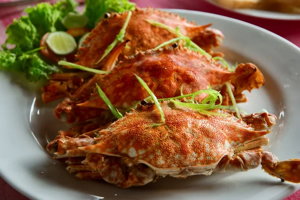 Three large red crabs with salad and lime — Stock Photo, Image