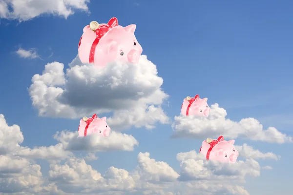 Pigs-coin boxes sit on white clouds in the blue sky