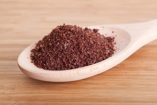 Sumac spice in a wooden spoon