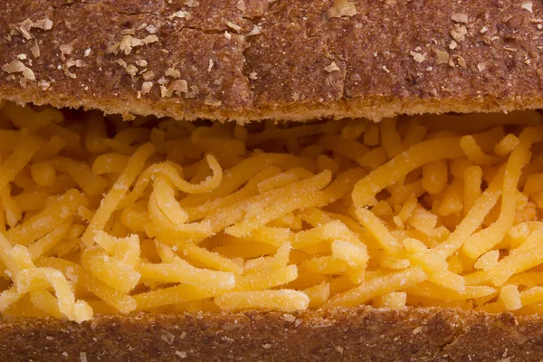 Sandwich with shredded cheese — Stock Photo, Image