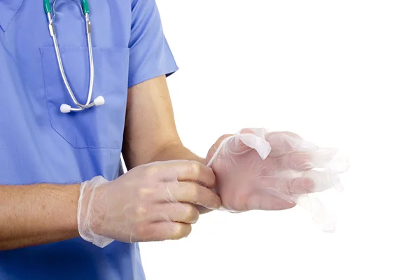 Lékař klade rukavice — Stock fotografie