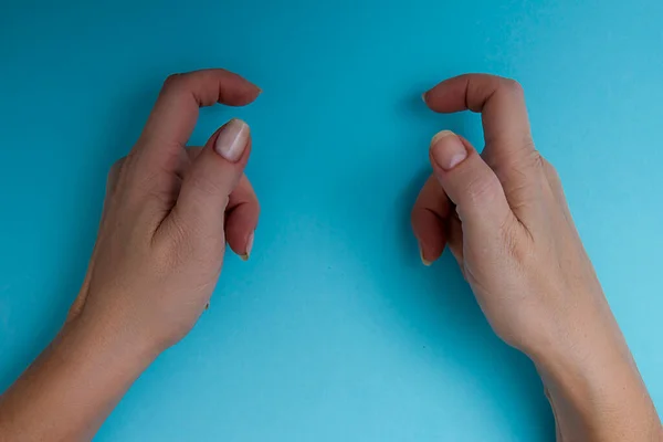 Female Hands Holding Object Blue Background — Stock Photo, Image