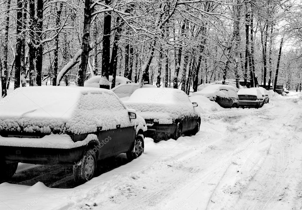 Cars under snow in black and white