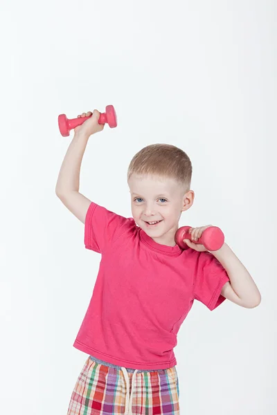 Boy in a red shirt and red dumbbells — Stock Photo, Image