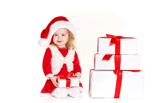 Child holding present wearing santa hat isolated on white — Stock Photo, Image