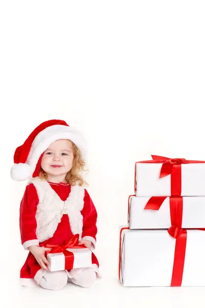 Child holding present wearing santa hat isolated on white — Stock Photo, Image