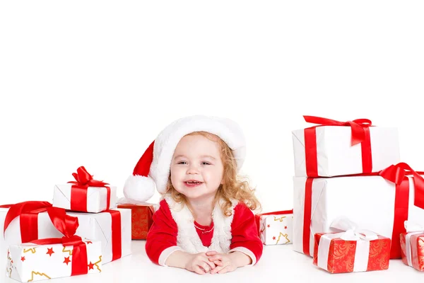 Child holding present wearing santa hat isolated on white — Stock Photo, Image