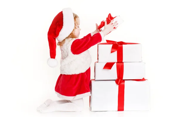 Child holding present wearing santa hat isolated on white Royalty Free Stock Photos