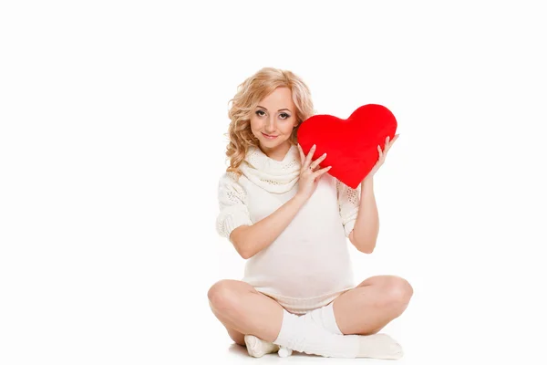 Junge Frau ist schwanger auf weißem Hintergrund — Stockfoto