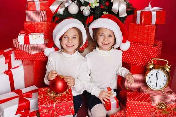 Happy teen sisters decorating Christmas tree — Stock Photo, Image