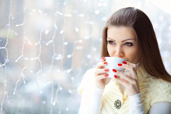 Mujer joven y bonita sentada en el café con una taza de café — Foto de Stock