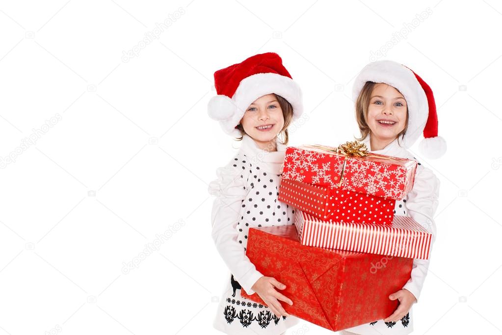 Happy teen sisters decorating Christmas tree