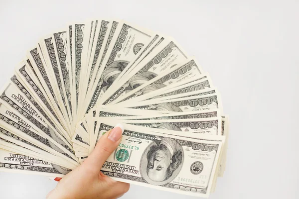 A young woman with dollars in her hands, isolated on white — Stock Photo, Image