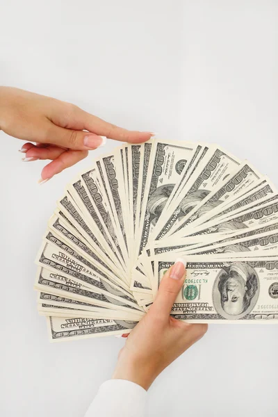 A young woman with dollars in her hands, isolated on white — Stock Photo, Image