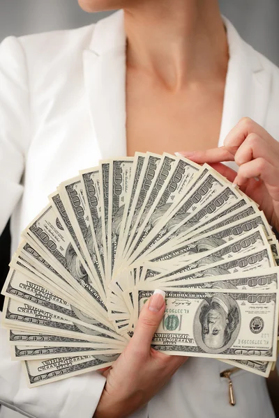 A young woman with dollars in her hands, isolated on white — Stock Photo, Image