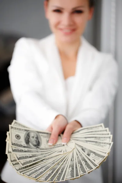 A young woman with dollars in her hands, isolated on white — Stock Photo, Image