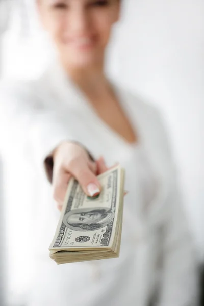 A young woman with dollars in her hands, isolated on white — Stock Photo, Image