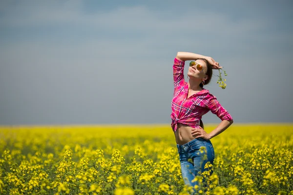 Mladá krásná žena v poli kvetoucí v létě. venkovní — Stock fotografie