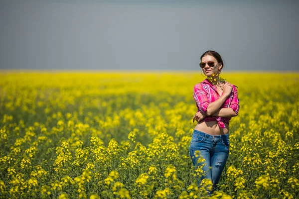 Mladá krásná žena v poli kvetoucí v létě. venkovní — Stock fotografie