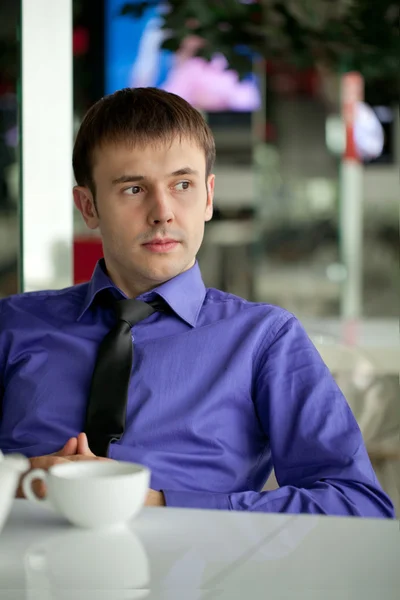 A young man in the office for a cup of tea — Stock Photo, Image