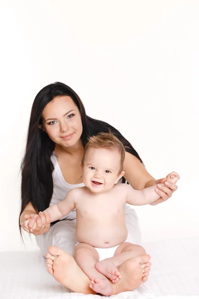 Portrait of mother playing with her baby infant isolated on white background — Stock Photo, Image