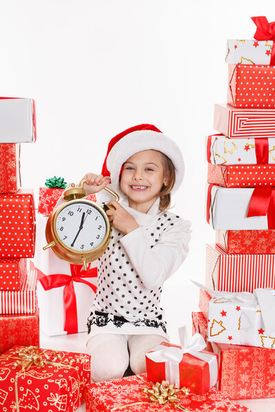 Portrait of Santa hat Christmas girls holding christmas gifts smiling happy and excited. Cute beautiful santa children on red background.