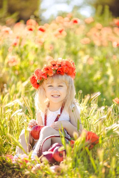 Schattig kind meisje in papaverveld — Stockfoto