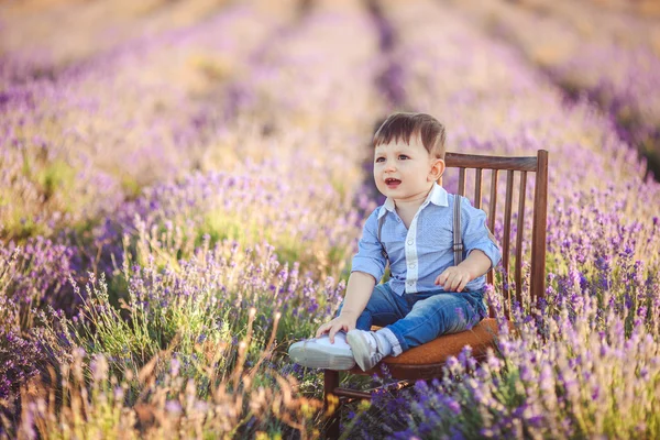 Modieuze jongetje met plezier in lavendel zomer veld. — Stockfoto