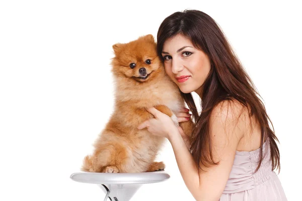 Happy woman and her beautiful little red dog spitz over white background close portrait — Stock Photo, Image