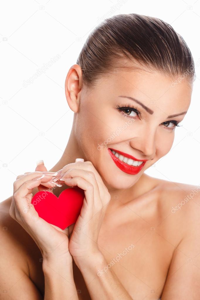 Portrait of Beautiful gorgeous smiling woman with glamour bright makeup and red heart in hand