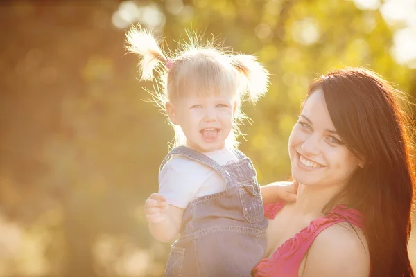 Young mother with child outside on a summer day — Stock Photo, Image