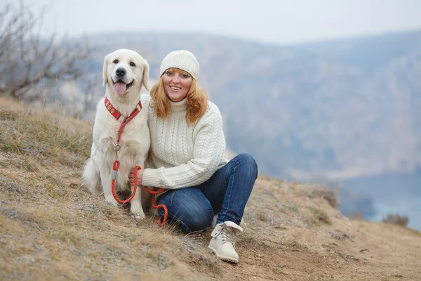 Hermosa chica con su perro cerca del mar — Foto de Stock