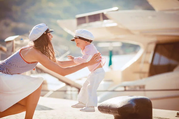 静物写真市海によって桟橋で遊んでいる息子を持つ母の肖像 — ストック写真