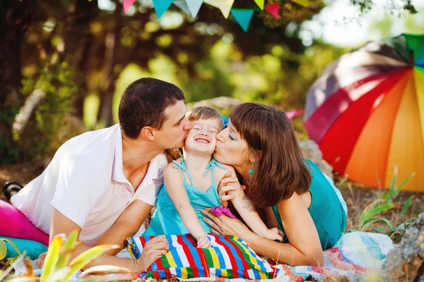 ग्रीष्मकालीन पार्क में आउटडोर आराम करने वाले बच्चे के साथ खुश युवा परिवार — स्टॉक फ़ोटो, इमेज