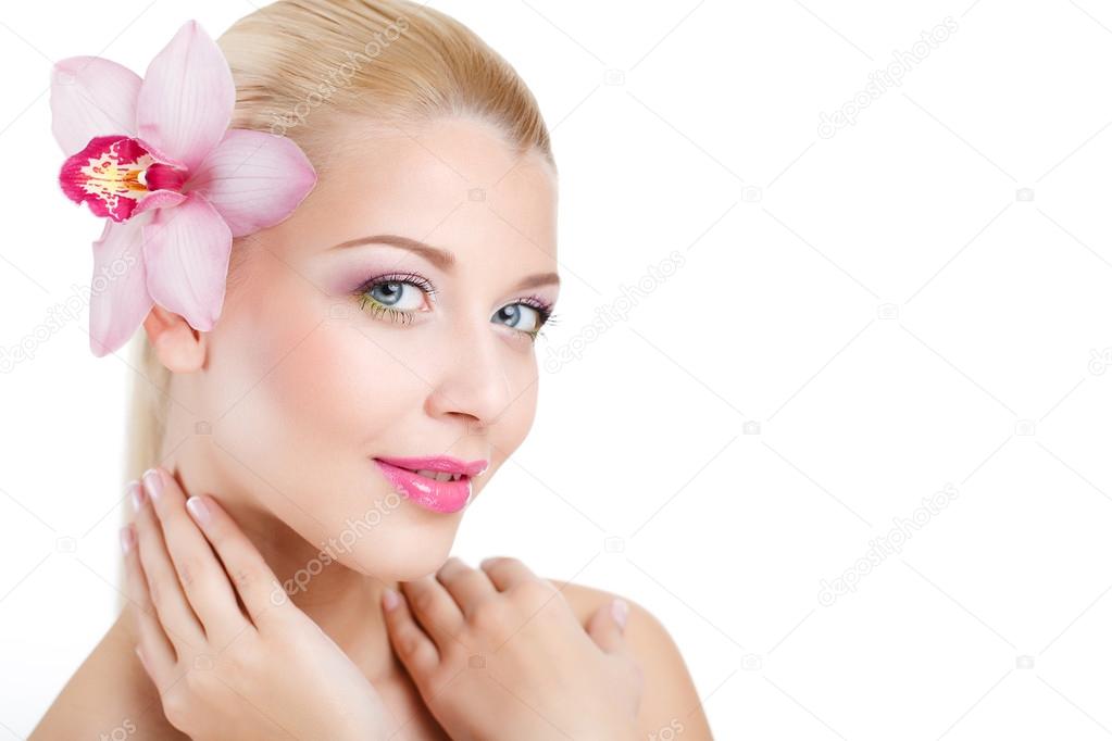 Portrait of Beautiful woman With Orchid Flower in her hair.Beautiful Model Woman Face. Perfect Skin. Professional Make-up.Makeup. Isolated on white background