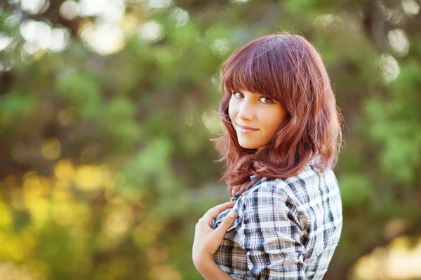 Portrait of young attractive fair-haired smiling woman at summer green park. — Stock Photo, Image