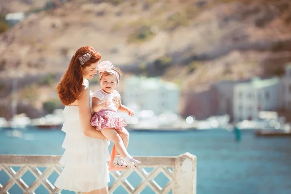 Porträt einer glücklichen Familie mit Frau und Kind, die sich im Sommer am blauen Meer amüsiert — Stockfoto