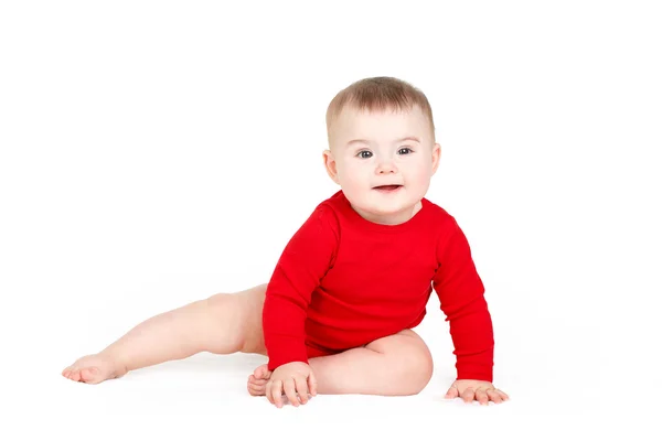 Porträt eines glücklichen entzückenden Säuglings Baby Mädchen lin rot sitzt glücklich lächelnd auf weißem Hintergrund — Stockfoto