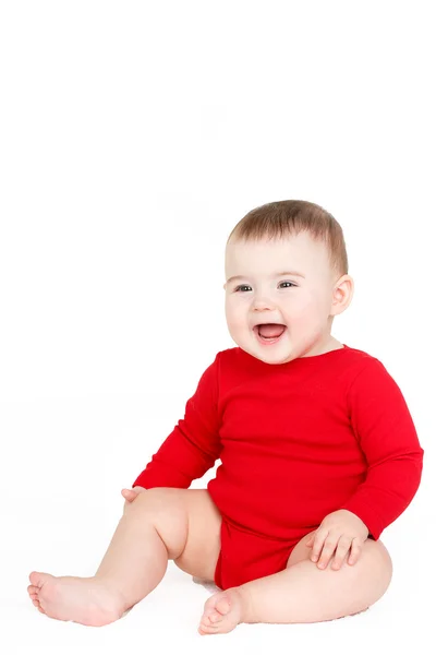 Portret van een meisje van de baby gelukkig schattige baby kind lin rood zitten gelukkig lachend op een witte achtergrond — Stockfoto