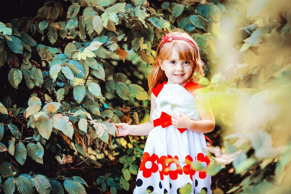 Portrait of beautiful little girl in summer green park — Stock Photo, Image