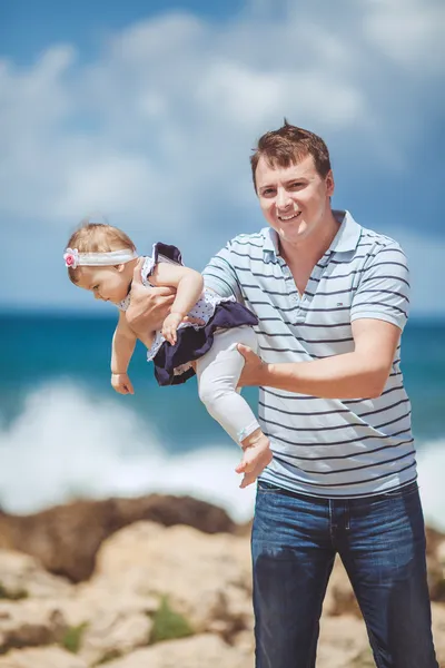 Portrait of a Happy family of man and infant child having fun by the blue sea in summertime — Stock Photo, Image