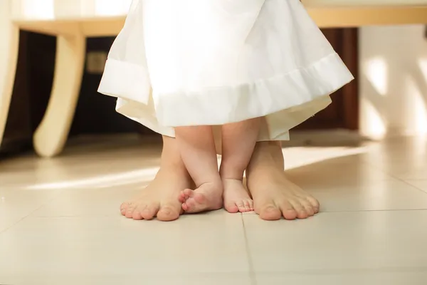 Portrait of Cute newborn foot with family members standing on the floor — Stock Photo, Image